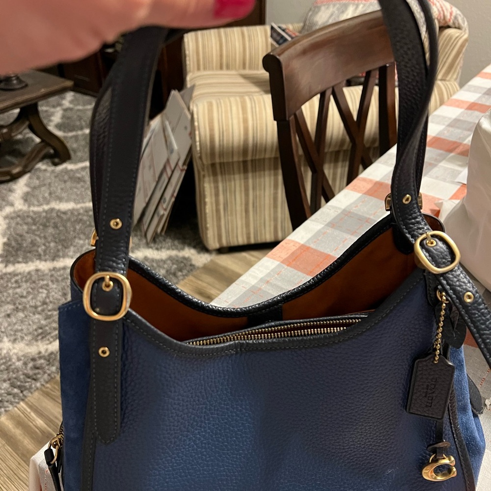 This gorgeous blue coach bag with leather and suede on the sides.